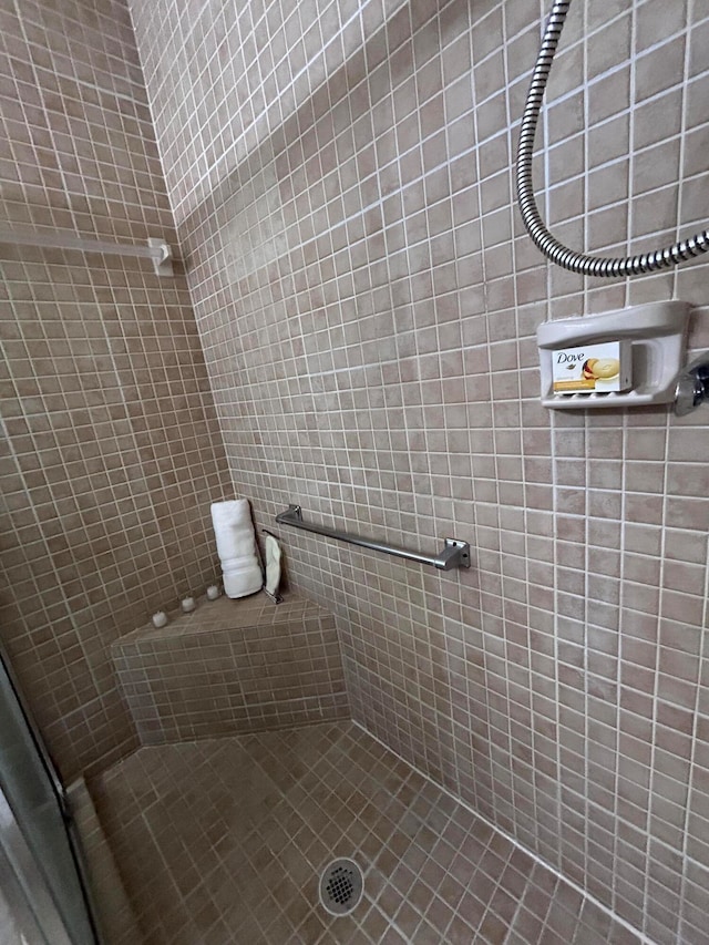 bathroom with a tile shower