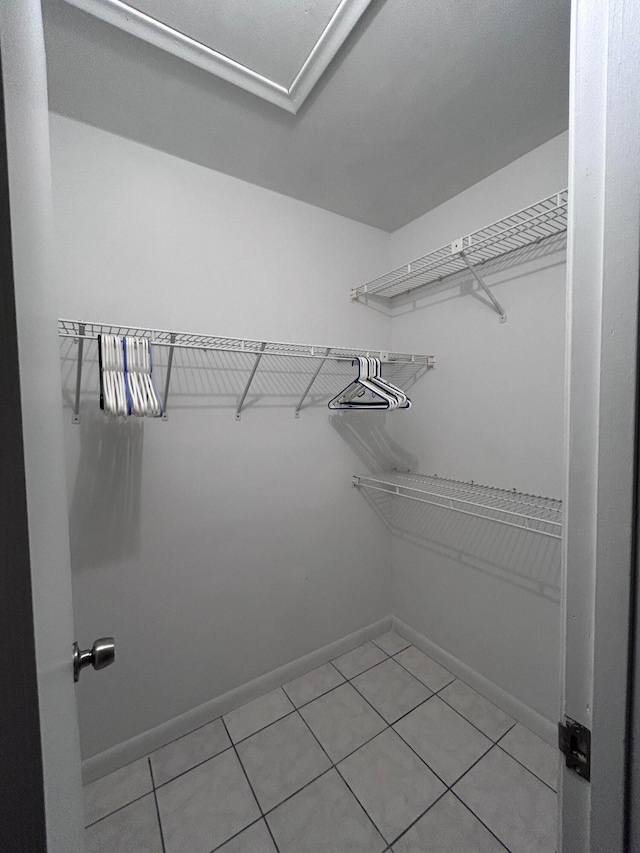 walk in closet with tile patterned floors