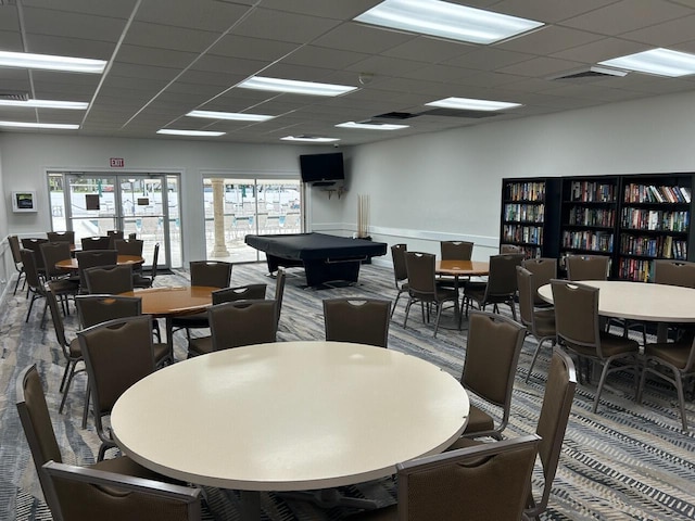 dining room featuring carpet, a drop ceiling, and billiards