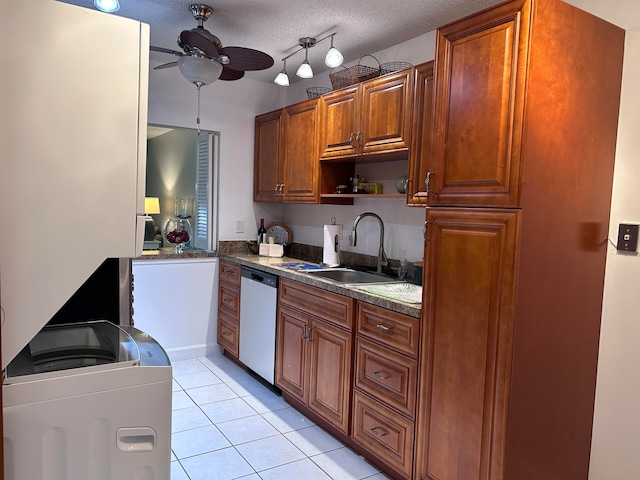 kitchen with a textured ceiling, ceiling fan, sink, light tile patterned floors, and dishwasher