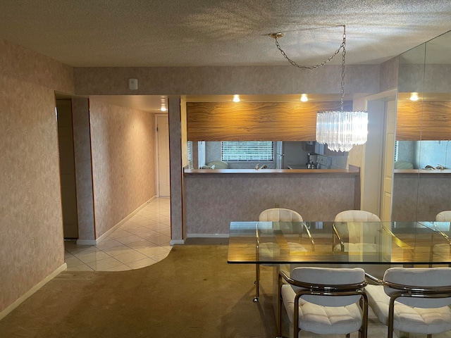 unfurnished dining area featuring a notable chandelier, carpet, and a textured ceiling