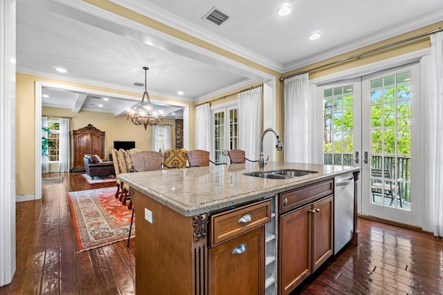 kitchen featuring a kitchen island with sink, french doors, hanging light fixtures, and dark hardwood / wood-style floors