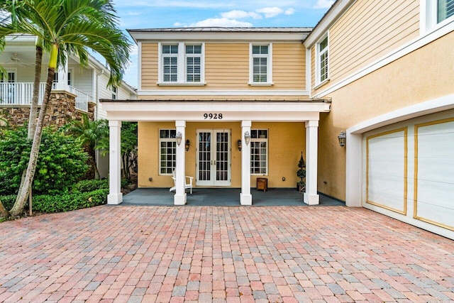 property entrance featuring a garage and covered porch