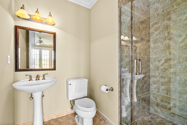 bathroom featuring toilet, sink, ornamental molding, ceiling fan, and a shower with shower door