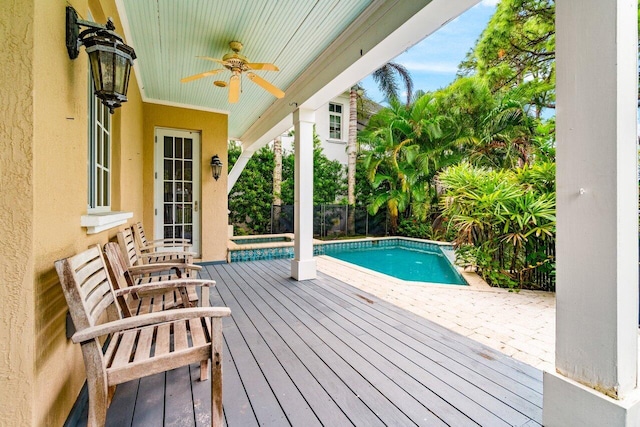 view of swimming pool featuring ceiling fan and a wooden deck