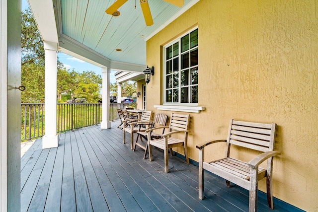 wooden deck featuring ceiling fan