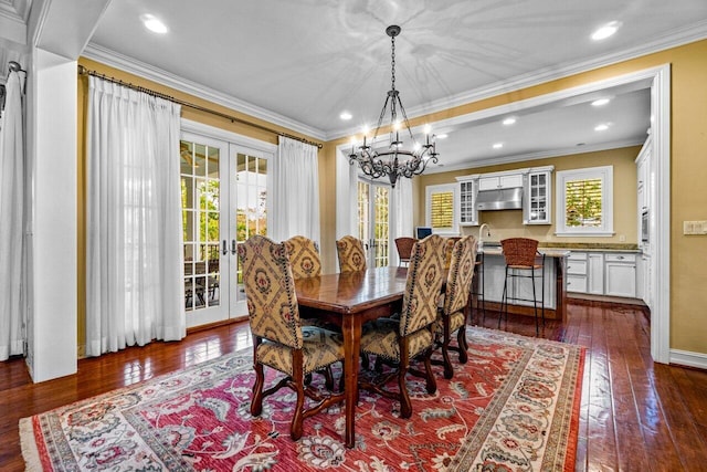 dining room with dark hardwood / wood-style flooring, french doors, ornamental molding, and plenty of natural light