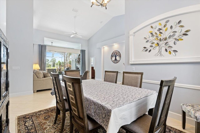 dining space with ceiling fan, light tile patterned floors, and high vaulted ceiling