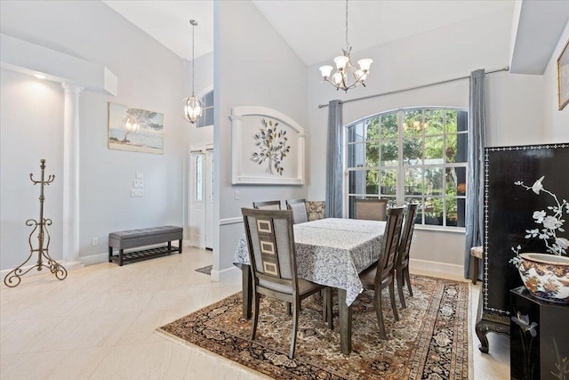 dining room featuring decorative columns, baseboards, an inviting chandelier, and high vaulted ceiling