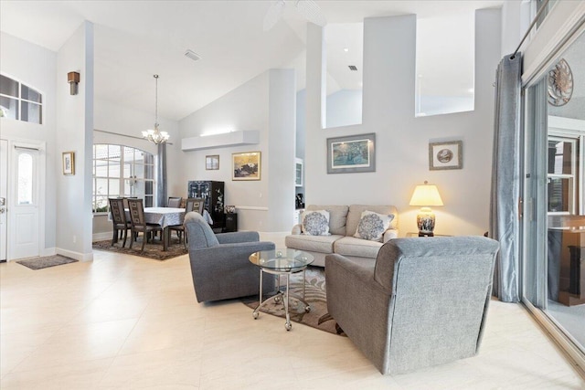 living area with high vaulted ceiling, baseboards, a notable chandelier, and visible vents