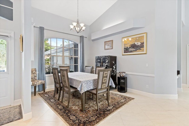 dining space featuring high vaulted ceiling, an inviting chandelier, light tile patterned flooring, and baseboards