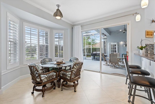 tiled dining room with ceiling fan, a healthy amount of sunlight, and crown molding