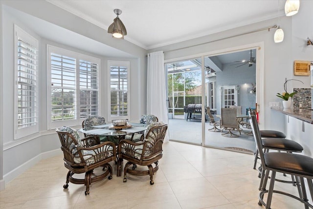 dining space with light tile patterned floors, ceiling fan, baseboards, and ornamental molding