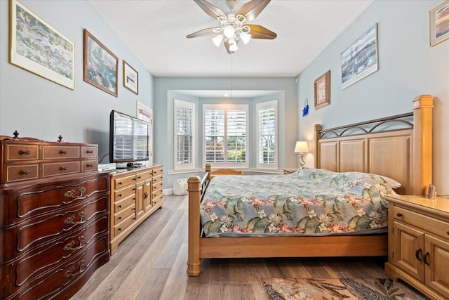 bedroom with light hardwood / wood-style floors and ceiling fan