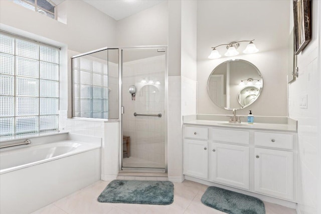 bathroom with vanity, plus walk in shower, tile patterned floors, and a healthy amount of sunlight