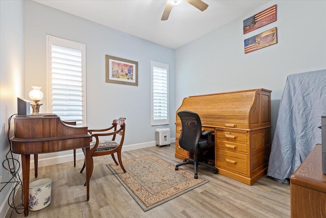 office area with light wood-type flooring, baseboards, and ceiling fan