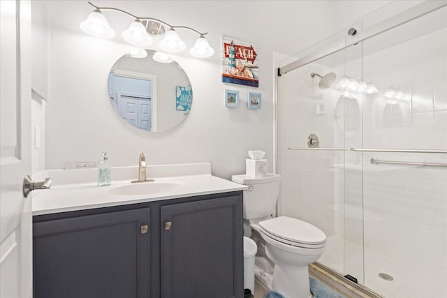 bathroom featuring vanity, toilet, and an enclosed shower