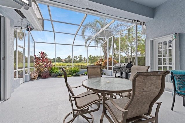 view of patio / terrace with a lanai, a grill, and outdoor dining area