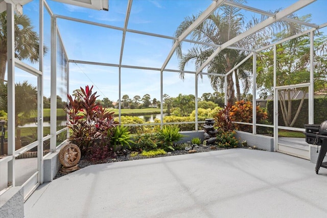 unfurnished sunroom featuring a water view