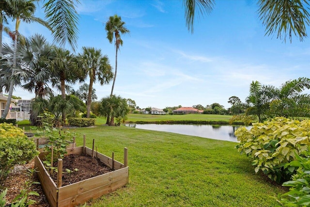 view of yard featuring a garden and a water view