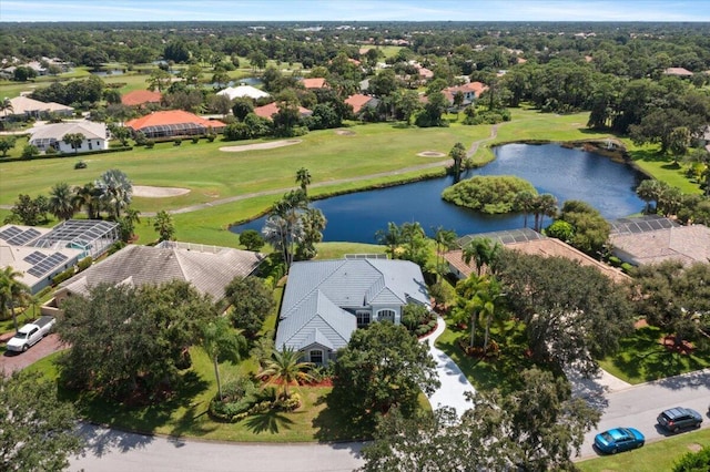 drone / aerial view with view of golf course, a water view, and a residential view