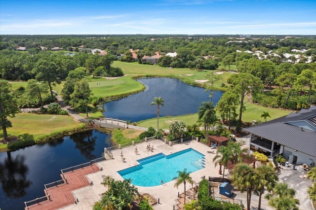 drone / aerial view with view of golf course and a water view
