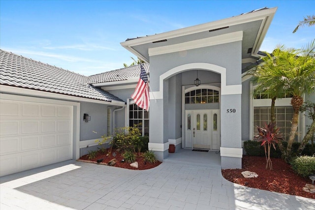 doorway to property with a garage