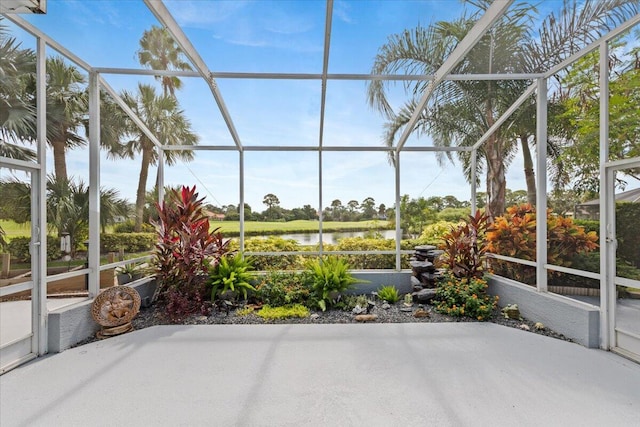 unfurnished sunroom with a water view