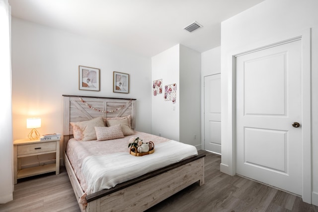 bedroom featuring visible vents and light wood finished floors