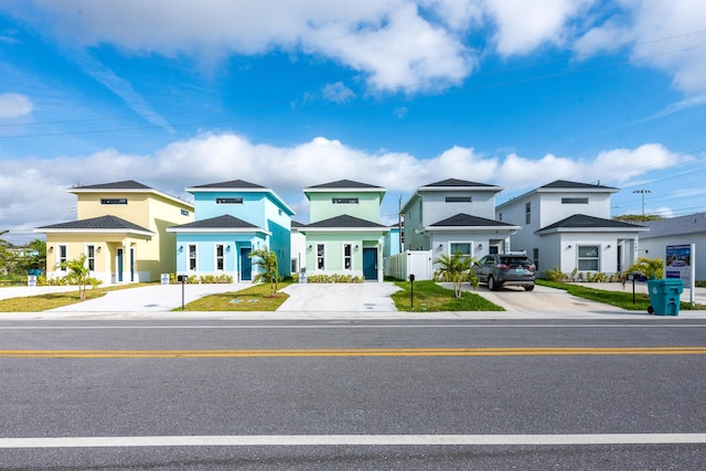 view of front of property featuring a residential view and concrete driveway