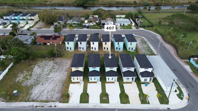 bird's eye view with a residential view and a water view