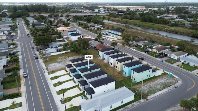 bird's eye view with a water view and a residential view