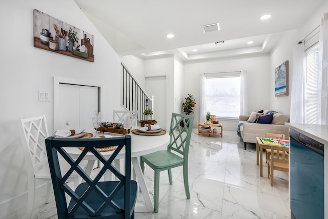 dining room featuring visible vents, a tray ceiling, recessed lighting, stairs, and marble finish floor