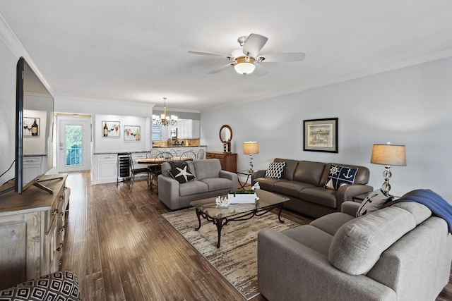 living room featuring ceiling fan with notable chandelier, wine cooler, dark hardwood / wood-style floors, and ornamental molding