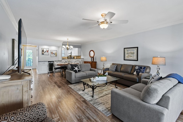 living room featuring ceiling fan with notable chandelier, wine cooler, crown molding, and dark hardwood / wood-style flooring