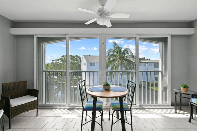 interior space with a wealth of natural light, ceiling fan, and light tile patterned floors