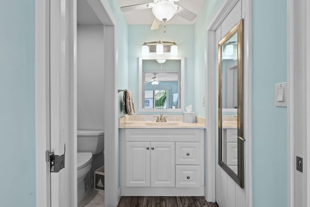 bathroom featuring hardwood / wood-style floors, ceiling fan, vanity, and toilet