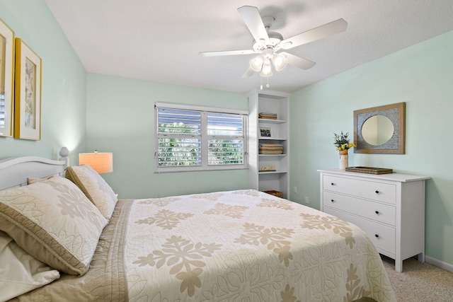 bedroom with ceiling fan and light colored carpet