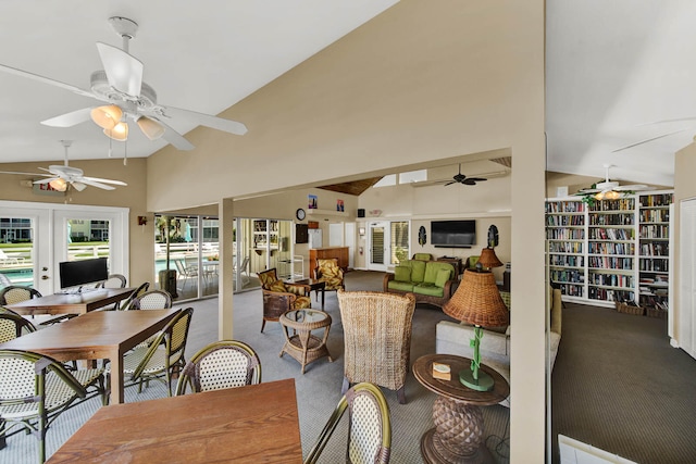 dining area featuring ceiling fan, carpet, and high vaulted ceiling