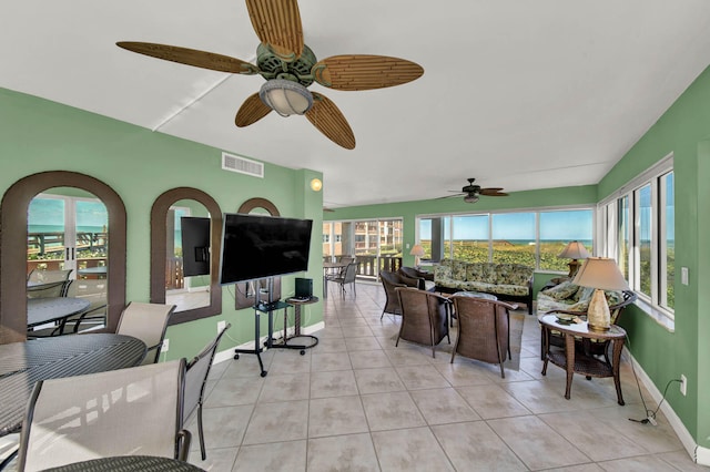 sunroom / solarium featuring ceiling fan