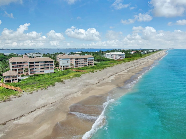 birds eye view of property with a view of the beach and a water view