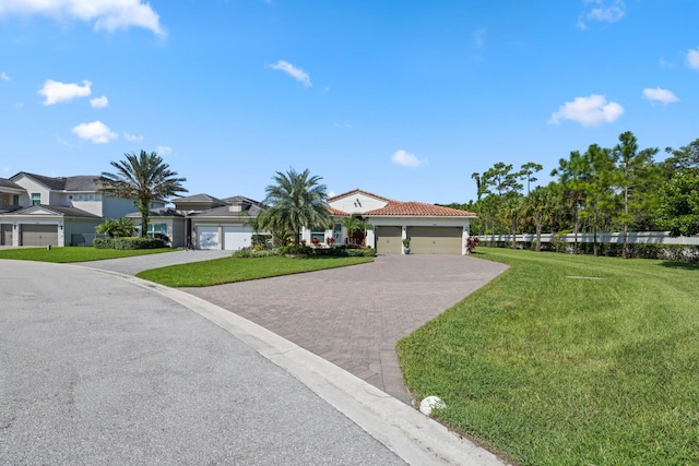 view of front of property with a front yard and a garage