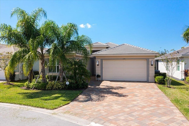 view of front facade with a front yard and a garage