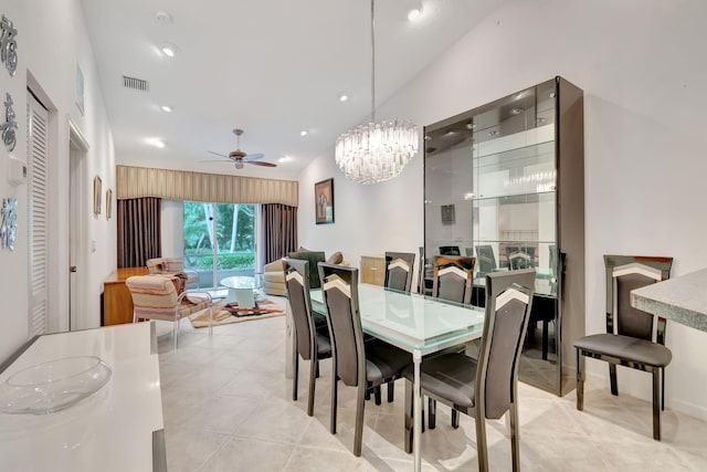 dining room with lofted ceiling, light tile patterned flooring, and ceiling fan with notable chandelier