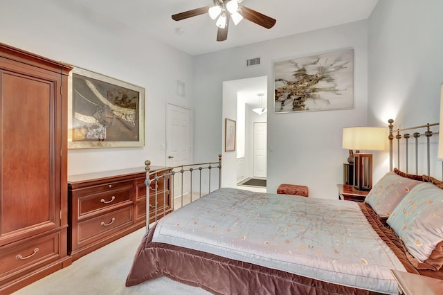 bedroom with ensuite bath, carpet, and ceiling fan