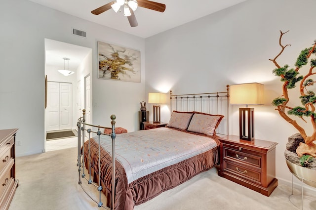 bedroom featuring light carpet, a closet, and ceiling fan