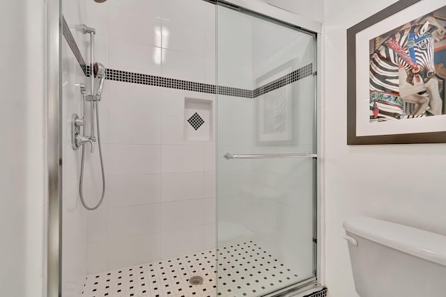 bathroom featuring toilet and walk in shower