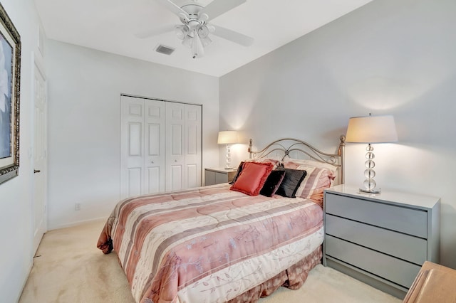 carpeted bedroom featuring a closet and ceiling fan