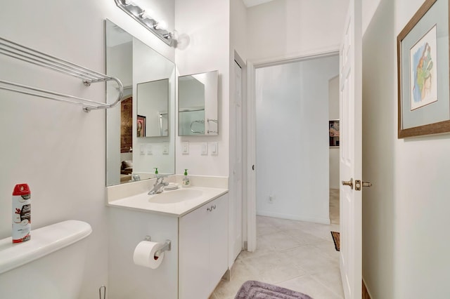 bathroom with vanity, toilet, and tile patterned flooring