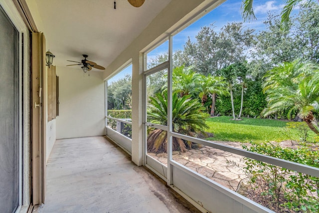 unfurnished sunroom featuring ceiling fan